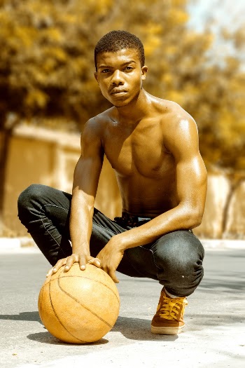 Shirtless Man Holding a Basketball