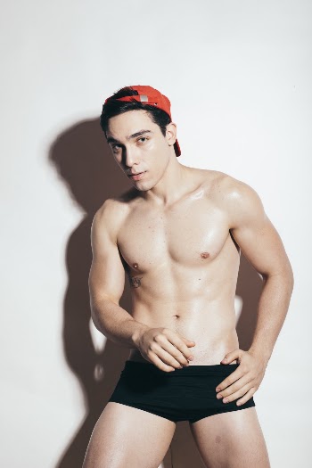 Shirtless Man in Black Boxer Shorts and Red Cap