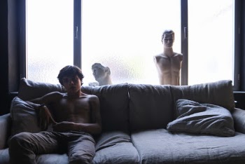Shirtless Man Sitting on Sofa