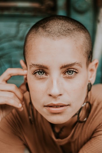 Short-haired Woman Holding Her Ear