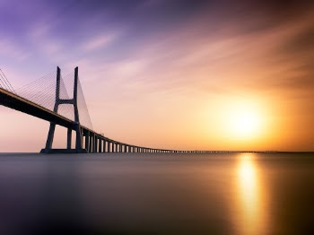 Shot from the bank of the Tagus river in Lisbon at sunrise, this is a single 5 minute exposure.