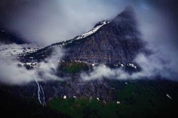 Shot on Going to the Sun Road in Glacier NP, Montana, USA. The sunset light I had hoped for was replaced with an overcast sky and some low cloud cover. I was pretty much done for the evening when I was driving back and noticed the fast moving clouds moving among the mountains.