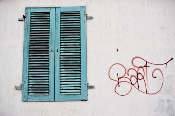 shut teal wooden window at daytime