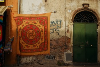 Sicily Italy street market with African native traditional pattern fabric hanging