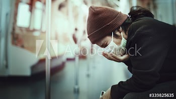 Sick woman in a mask coughing in public during coronavirus pandemic