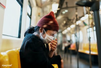 Sick woman in a mask sneezing in a train during coronavirus pandemic | Free  photo - 2290768