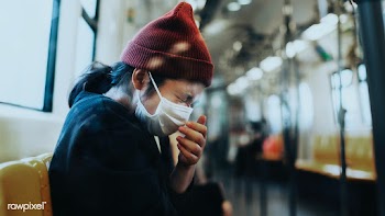 Sick woman in a mask sneezing in a train during coronavirus pandemic | Free  photo - 2297132