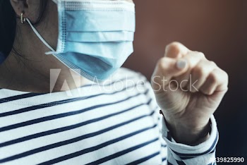 Sick woman wearing a face mask to stop the spread of coronavirus