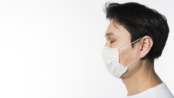 Side view of sick man wearing a medical mask Free Photo