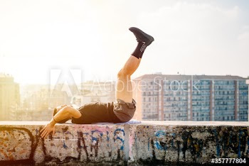 Side view of young man exercising outdoors