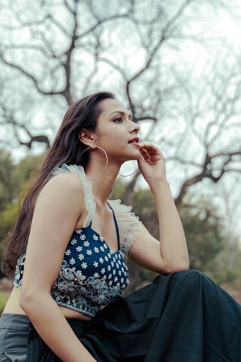 Side View Photo of a Woman Sitting Outdoors 