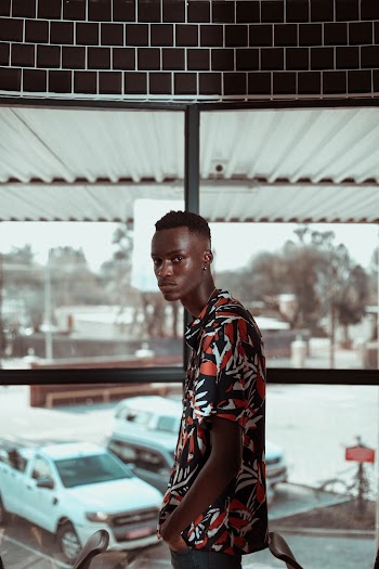 Side View Photo of Man in Floral Shirt Posing