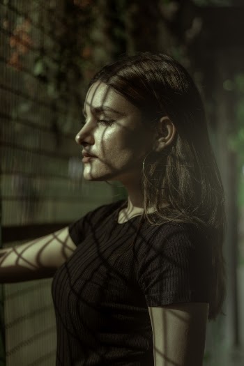 Side View Photo Of Woman Beside Fence