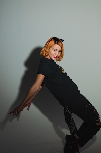 Side View Photo of Woman Doing a Tiptoe Pose In Front of White Background