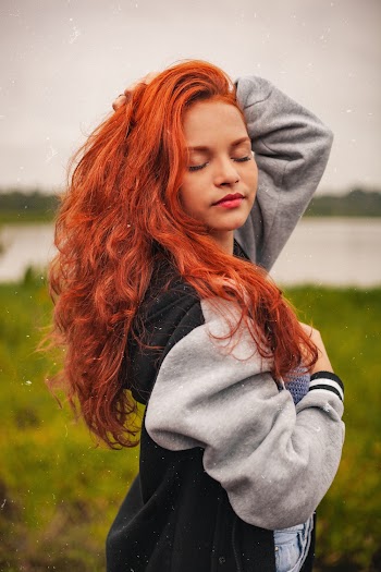 Side View Photo of Woman in Black and Grey Jacket Posing with Her Eyes Closed