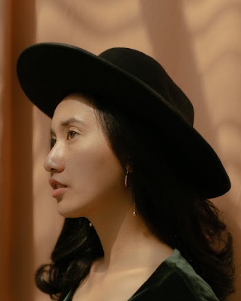 Side View Photo of Woman in Black Fedora Hat Posing Looking Away 