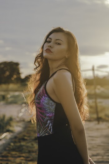 Side View Photo of Woman in Black Outfit Posing Outside