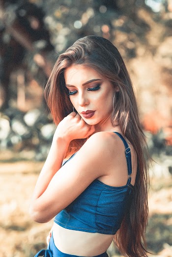 Side View Photo of Woman in Blue Crop Top Looking over Left Shoulder