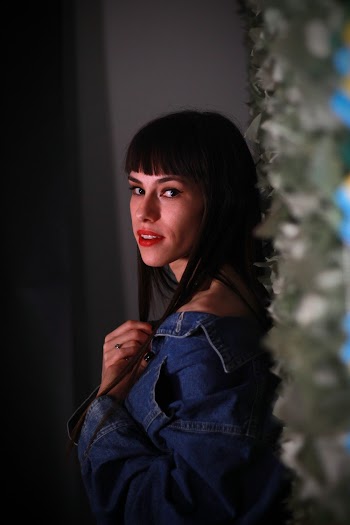 Side View Photo of Woman in Denim Jacket Posing