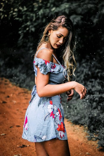 Side View Photo of Woman in Floral Dress Looking Down