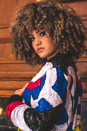 Side View Photo of Woman in Multicolored Sweater Posing