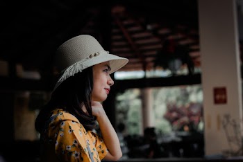 Side View Photo of Woman in Sun Hat Looking Out