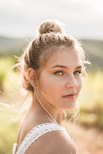Side View Photo of Woman in White Top