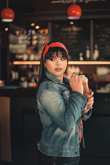 Side View Photo of Woman Posing With a Glass of Frappe Coffee Looking Away