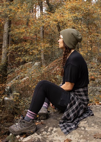 Side-view Photo of Woman Sitting on Rock
