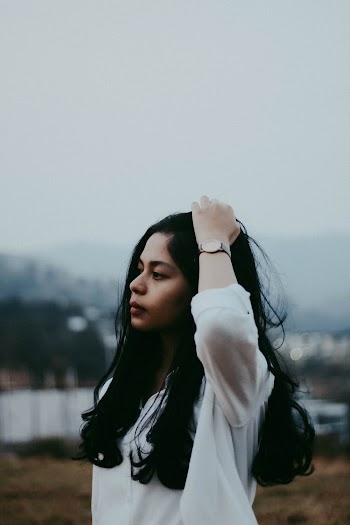 Side View Photo of Woman Touching Her Head