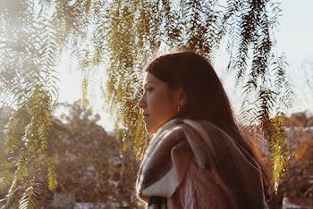 Side View Photo of Woman Under Green Tree Leaves