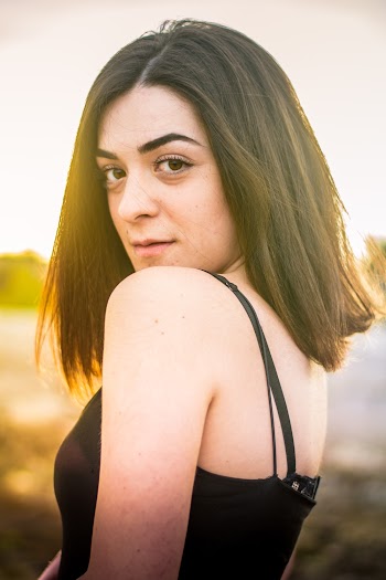 Side View Photo of Woman Wearing Black Spaghetti Strap Top Posing