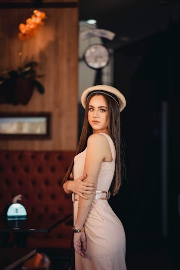 Side View Photo of Woman Wearing Pink Dress and Hat Posing