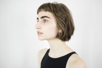 Side View Portrait Photo of Woman in Black Sleeveless Top