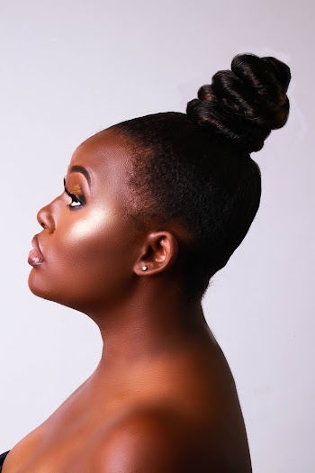 Side View Portrait Photo of Woman Posing In Front of White Background