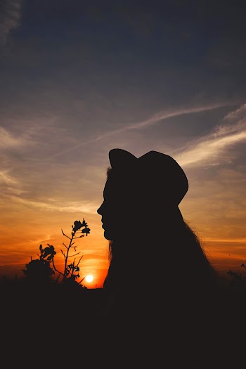 Side View Silhouette Photo of Woman in Fedora Hat