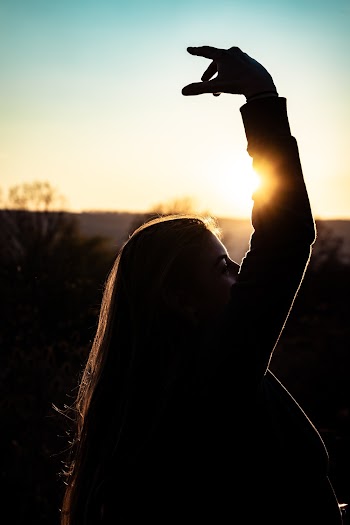 Side View Silhouette Photo of Woman With Hand Raised