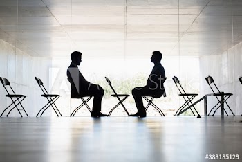 Silhouette businessmen sitting face to face