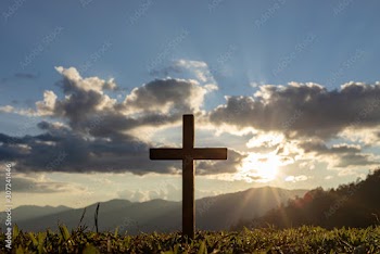 Silhouette cross on mountain at sunset background.Crucifixion Of Jesus Christ