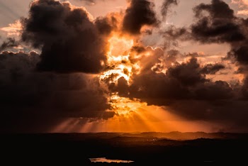 Silhouette Image of Body of Water Under Clouds