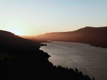 silhouette mountain and river during sunset