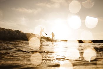 silhouette of 2 person near on the body of water