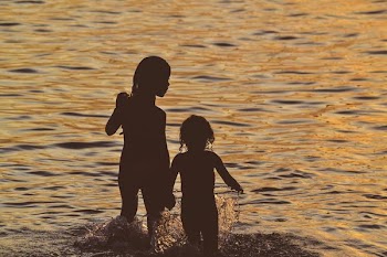 silhouette of a girl running on the body of water