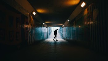 silhouette of a man inside subway
