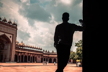 Silhouette of a Man Standing Near Building