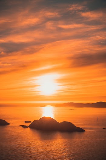 Silhouette of Black Stone Across Horizon during Sunset