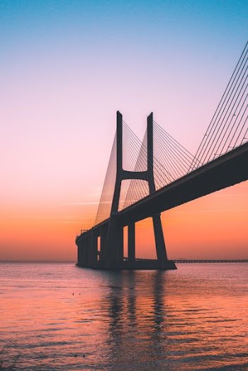 silhouette of bridge under clear sky