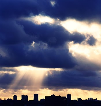 Silhouette of Building Under Cloudy Sky