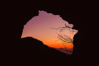 silhouette of cave during sunset