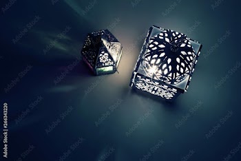 Silhouette of glowing Moroccan ornamental lanterns at night with decorative shadows. Greeting card, invitation for Muslim holy month Ramadan Kareem. Festive background. Flat lay, top view. Iftar table